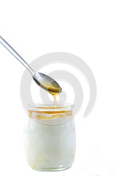 Honey Yogurt. Greek yogurt with honey in a glass jar with honey product