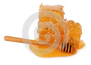 Honeybee honeycomb piece with liquid yellow natural honey and wooden clap isolated on white background