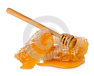 Honeybee honeycomb piece with liquid yellow natural honey and wooden clap isolated on white background