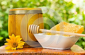 Honeycomb and barrel of honey