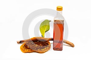 Honeycomb on a branch and honey in a plastic bottle on a white background photo