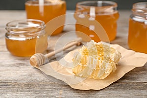 Honeycomb, dipper and jars on table