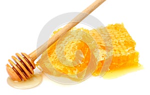 Honeycomb with honey dipper and honey isolated on white background