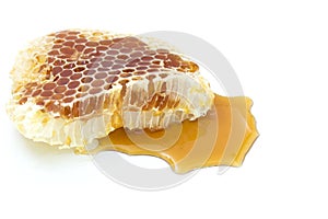 Honeycomb with honey dipper isolated on white background