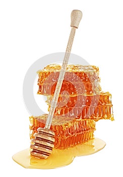 Honeycomb with honey dipper isolated on white background. Organic and natural bee products