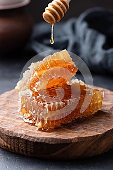Honeycomb and honey dipper with liquid honey