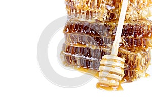 Honeycomb with honey and honey stick on white background