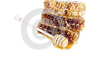 Honeycomb with honey and honey stick on white background