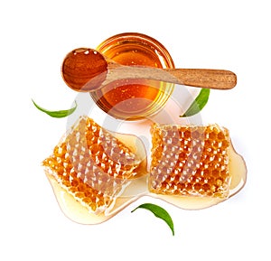 Honeycomb with jar and honey spoon and leaf isolated on white background