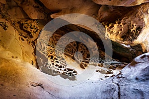 Honeycomb weathering in a natural sandstone. Eroded rock in cliffs. Rock weathering cave