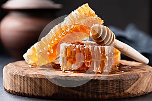 Honeycomb and wooden honey dipper