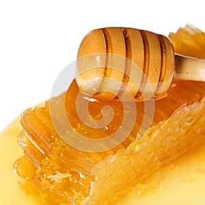 Honeycomb with Wooden Honey Dipper, isolated on white background