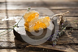 Honeycomb and wooden honey dipper. Raw honey. Natural honey, closeup view