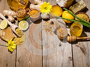 Honeycombs ,honey, ginger, pollen, lemon on a table