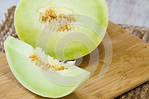 Honeydew Melon Slice on Wooden Cutting Board photo