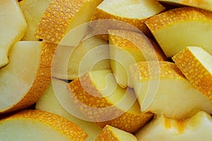 Honeydew melon slices, full frame food background, top view.
