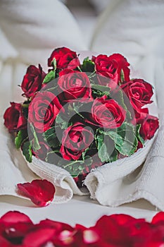 honeymoon bed look like heart shape with rose petals for honeymoon lover.