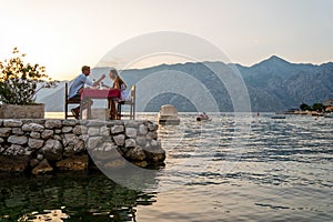 Honeymoon couple is having a private, romantic dinner at a tropical beach