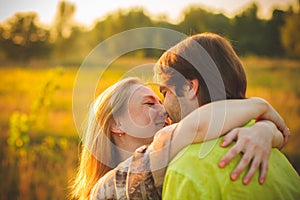 Honeymoon couple romantic in love at field and trees sunset. Newlywed happy young couple embracing enjoying nature