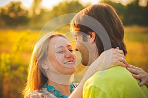 Honeymoon couple romantic in love at field and trees sunset. Newlywed happy young couple embracing enjoying nature