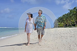 Honeymoon couple walks on a tropical pacific island beach in Rarotonga Cook Islands