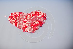 Honeymoon suite, Wedding bed topped with rose petals set to heart from for valentine.