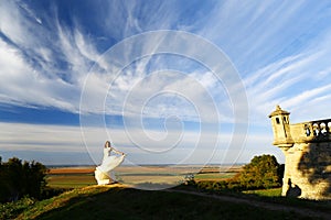 Honeymoon Trip, Bride in Wedding Dress over Blue Sky, Romantic Travel Concept, Looking Ahead. free space for text