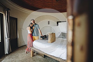 Honeymooners checking in to a hotel room