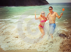 Honeymooners couple resting at ocean wave photo
