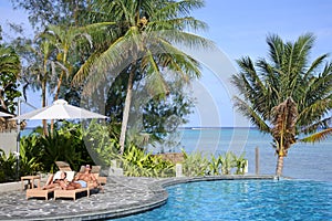 Honeymooners relaxing on a poolside in Rarotonga Cook Islands