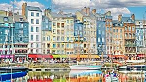 Beautiful harbor promenade with typical colorful old houses and boats