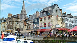 View on harbor promenade with typical breton old houses and boats