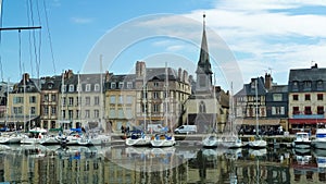 View on harbor promenade with typical breton old houses and boats
