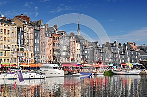 Honfleur harbour in Normandy France. Color houses and their reflection in water