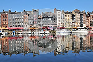 Honfleur harbour in Normandy France. Color houses and their reflection in water