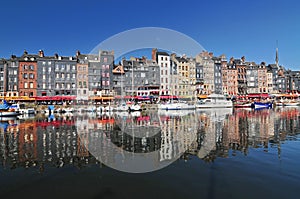 Honfleur harbour in Normandy France. Color houses and their reflection in water