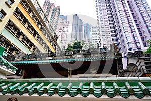 Hong Kong Apartment Buildings behind roof of old Temple, private tenements in Hong Kong, China