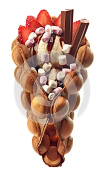 Hong kong or bubble waffle with ice cream, chocolate and strawberries