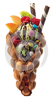 Hong kong or bubble waffle with ice cream, fruits and candy