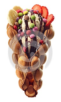 Hong kong or bubble waffle with ice cream, fruits and candy