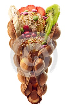 Hong kong or bubble waffle with ice cream, fruits and candy photo