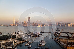 HONG KONG, CHINA - CIRCA 2020: Hong Kong Skyline and Victoria Harbor in morning. Sunset over Hong Kong bay on a clear day