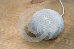 Hong Kong, China - 12 December, 2017:Google Home Mini Chalk color on a wooden surface