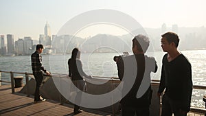 Hong Kong, China - January 1, 2016: People in the harbor of Victoria in Hong Kong. View of the sea and the city from the