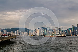 Hong Kong skyline cityscape downtown skyscrapers over Victoria Harbour with tourist ferry boat