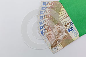 Hong Kong dollar bank notes money in green envelope on white background, Five Hundred Hong kong Dollars