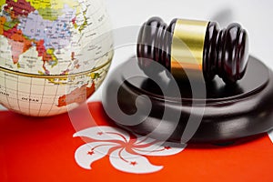 Hong Kong flag and Judge hammer with globe world map. Law and justice court.