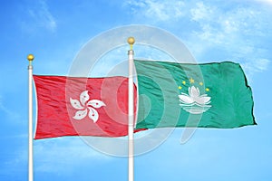 Hong Kong and Macau two flags on flagpoles and blue cloudy sky photo