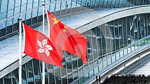 Hong Kong and mainland China national flags stand together with copy space. Nation symbol, countries political conflict concept