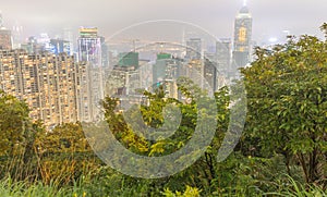 HONG KONG - MAY 12, 2014: City skyline from Victoria Peak at night. Hong Kong attracts 25 million people annually